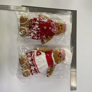 Detail shot of two Christmas gingerbread plush dolls with measuring scale showing 28cm height