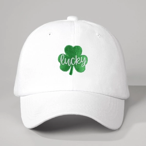 Close-up of green clover embroidery and white lucky lettering on washed cotton baseball cap