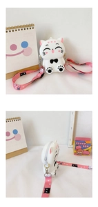 Close-up of white cat-shaped silicone crossbody bag with pink strap and zip closure