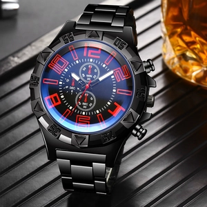 Macro shot of black stainless steel quartz watch with red numerals and blue light glass