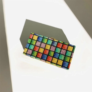 Close-up of rainbow crystal rhinestones on a rectangle evening clutch with gold metal frame