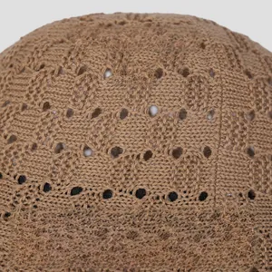 Detailed close-up of breathable khaki knit bucket hat with hollow-out crochet pattern