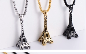 Detailed side view of Eiffel Tower pendants in silver, gold, and black with Paris engraving