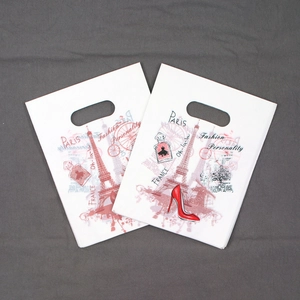 Detail of white plastic gift bag featuring French-style Paris themed art and die-cut handles