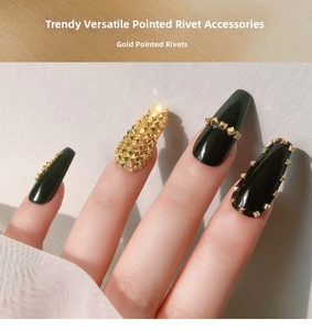 Detailed view of punk style gold pointed metal rivets on dark long nails for nail art