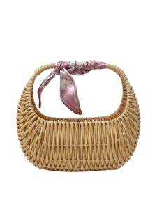 Brown woven rattan handbag with elegant pink floral scarf and top handle on white background
