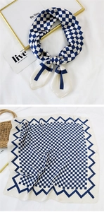 Detail of navy and beige checkered silk scarf with zigzag borders and silky texture