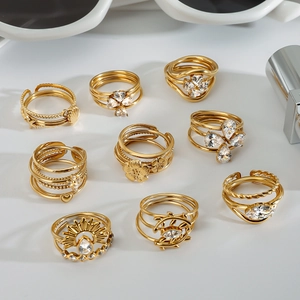 Golden geometric rings set with heart and shell designs and clear zircon inlays