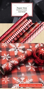 Detail of red Christmas wrapping paper set with snowflakes and grid patterns in 50x70cm size