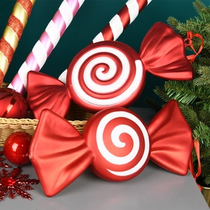 Red and white spiral candy Christmas ornaments displayed on a festive holiday backdrop