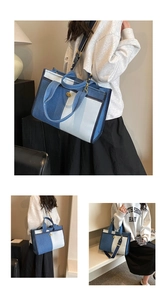 Détail du sac cabas en denim bicolore avec fermoir doré et bandoulière large rayée