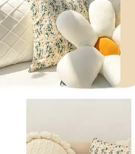 Detail of embroidered daisy pillow cases and textured cushions for home decor