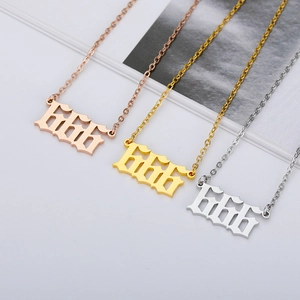 Detail of gothic 666 angel number pendants in rose gold, gold, and silver stainless steel