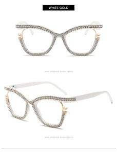 Detail of white cat eye glasses with rhinestones, gold accents and pearl embellishments