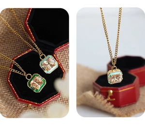 Detail of square zircon pendant necklace with colorful enamel border on golden chain
