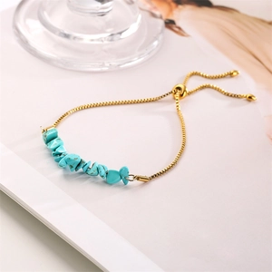 Detail of adjustable gold box chain bracelet with vibrant blue natural raw stones