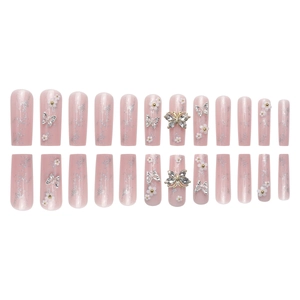 Nude pink coffin press-on nails with silver glitter, 3D floral accents and butterfly charms