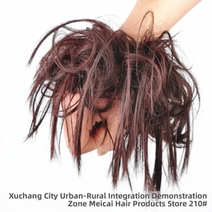 Close-up of messy bun hair piece in dark brown with auburn highlights for hair volume