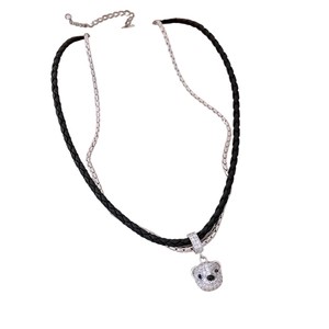 Double-layer bear pendant necklace with black leather cord and crystal-studded silver chain