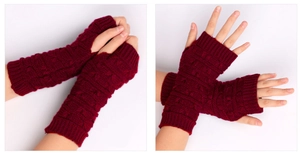 Detail view of burgundy cable knit fingerless gloves with thick texture and warm finish