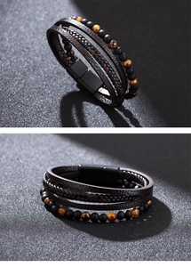 Detail of multi-layer braided leather bracelet with tiger eye beads and black magnetic clasp