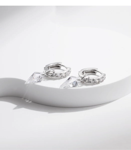 Close-up of S925 sterling silver hoop earrings with sparkling cubic zirconia pendants