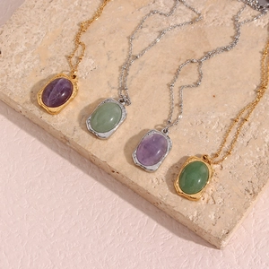 Detailed view of vintage oval natural stone pendants with gold and silver hammered textures