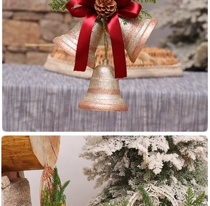 Detail of Christmas gold bell with red bow and pinecone next to snowflake pendant