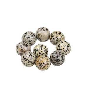 Polished dalmatian jasper sphere beads set on white background for crystal crafts