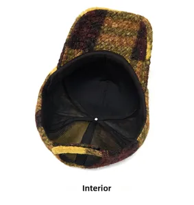 Detail view of the colorful plaid lamb wool baseball cap's black inner lining and stitching