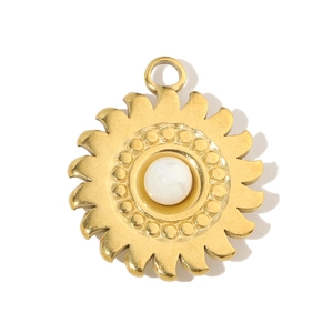 Detailed macro view of a golden sun-shaped pendant with a white central bead