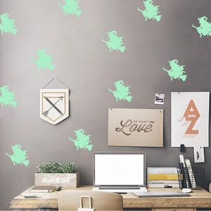Luminous Halloween wall stickers featuring glowing witches on broomsticks for home decor