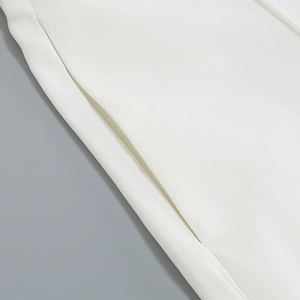 Detail of the stitching and fabric texture on a white blazer pocket for women