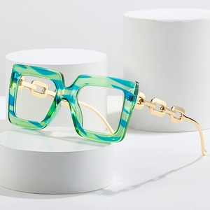 Oversized square glasses with blue-green marble frame and golden chain temples