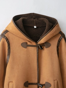 Detailed close-up of hooded suede coat with faux shearling lining and toggle closure