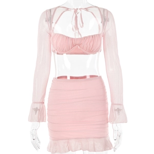 Macro detail of pink mesh two-piece set with ruffled edges and ruched sheer fabric