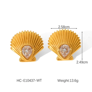 Macro view of 18K gold scallop shell earrings with cubic zirconia and size dimensions