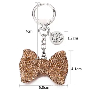 Sparkling rhinestone bow keychain with champagne crystals and silver swivel clasp for bags