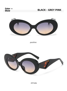 Detailed view of black oval sunglasses featuring wide temples and tortoiseshell accents