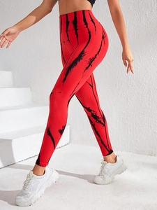 Detail view of high-waist seamless tie-dye yoga pants with red marble texture