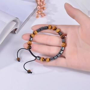 Macro view of adjustable beaded bracelet with yellow tiger eye and hematite stones