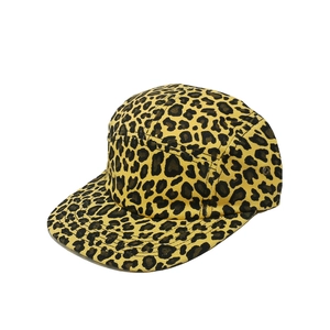 Detailed side view of leopard print five-panel camper hat with metal eyelets