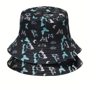 Two black bucket hats with mint green butterfly prints on premium cotton fabric for sun protection