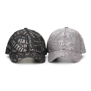 Detail of black and silver baseball caps with shiny metallic letter prints and curved brims