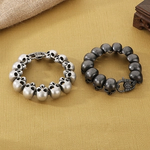 Close-up of vintage punk skull bracelets in antique silver and black finish steel