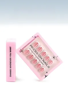 Detail of minimalist French tip press-on nails set in pink packaging with 30 nail pieces