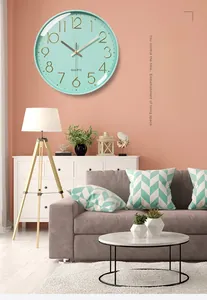 Silent quartz wall clock in mint green with 3D gold numbers in a modern living room