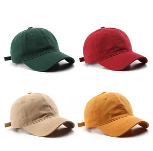 Detail view of cotton baseball caps in dark green, wine red, khaki, and yellow colors