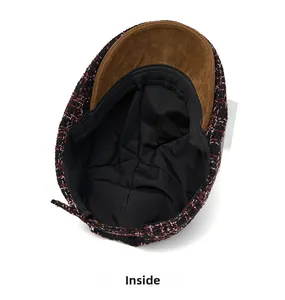 Detail view of tweed newsboy cap showing the black fabric lining and brown suede brim