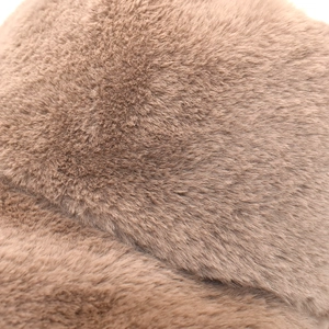 Detail of soft brown plush material on winter bucket hat showing thick faux fur texture